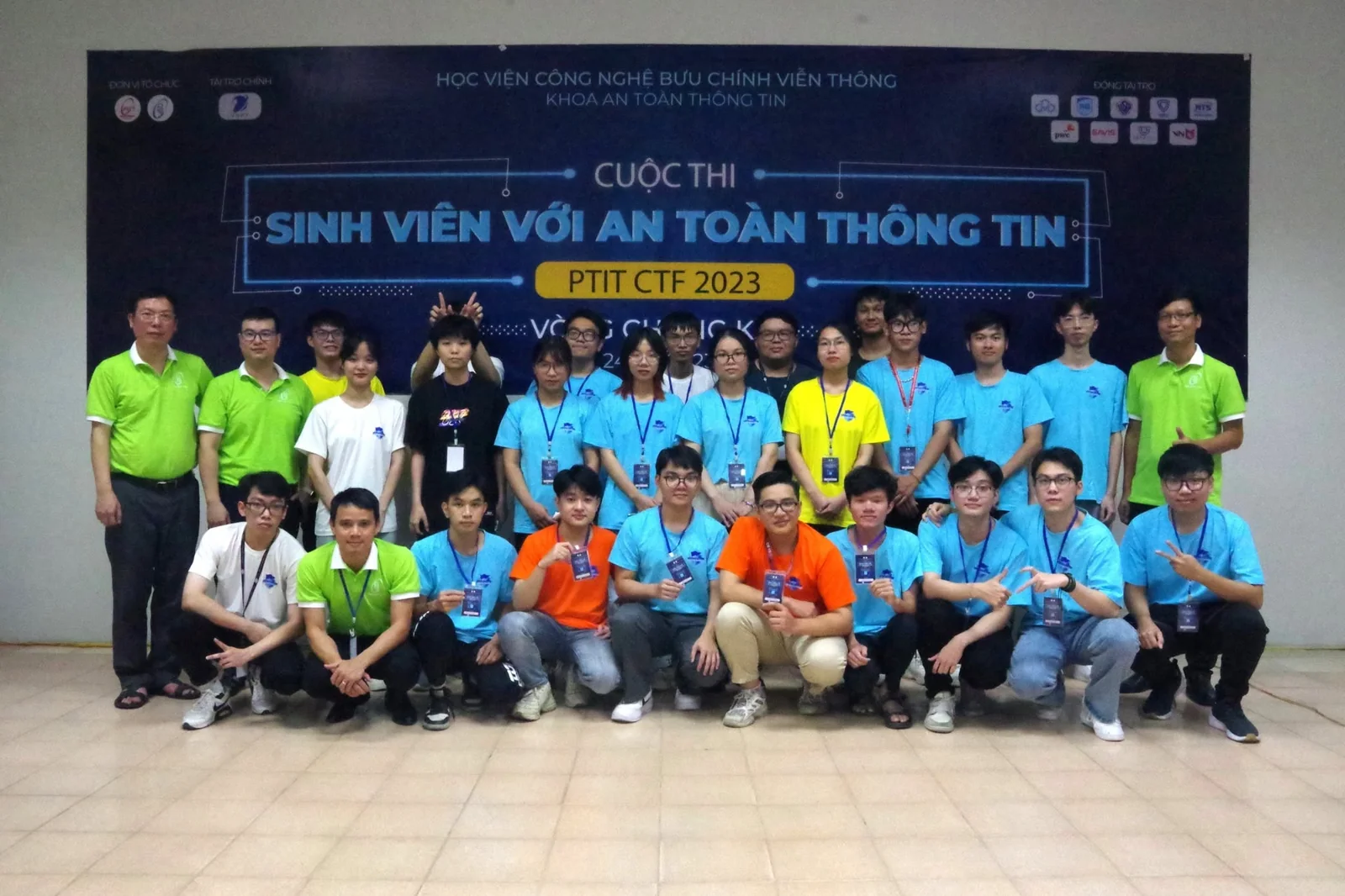 The PTIT CTF 2023 finalists with faculty members in front of the contest banner